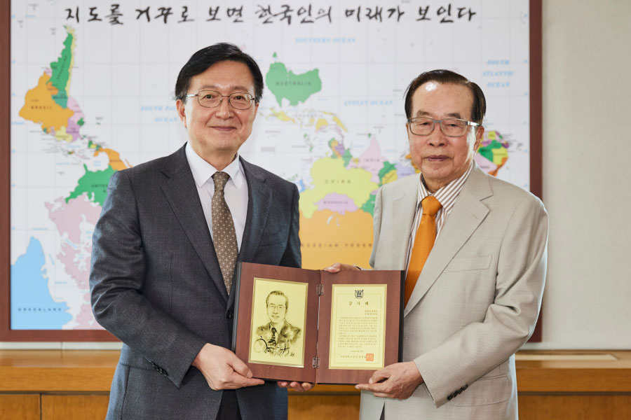 유홍림 총장과 김재철 이사장이 사진촬영을 하고 있다.